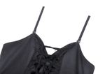 Close-up of edgy black distressed dress showing lace-up bodice and straps, perfect for a gothic night out.