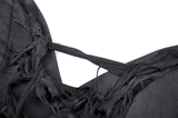 Close-up of edgy black dress detailing, showcasing distressed fabric and lace-up straps for a gothic look.