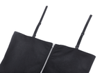 Close-up of stylish black dress with straps and zipper, showcasing a sleek and edgy design perfect for gothic fashion.