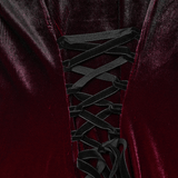 Close-up of adjustable lace-up back of gradient velvet dress, showcasing intricate black ribbon detailing.
