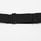 Close-up of a black strap showcasing a sturdy adjustable buckle, ideal for punk fashion and harness designs.