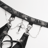 Close-up of an edgy black harness with chains, buckles, and a cross accent, perfect for alternative fashion enthusiasts.