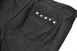 Edgy Pleated Shorts with Eyelet Accents and O-Ring Strap