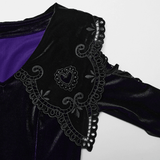 Close-up of lavender velvet dress with intricate heart-shaped lace collar and bell sleeves detailing.