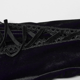 Close-up of intricate lace details and velvet fabric on a gothic dress, showcasing its elegant design elements.