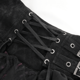 Close-up of the adjustable lacing details on a black tiered asymmetrical gothic skirt with edgy buckle accents.