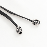 Black woven cord with silver skull beads for gothic accessories and edgy fashion.