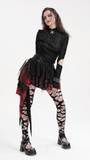 Bold gothic outfit featuring a tiered asymmetrical skirt in black and red, paired with fishnet stockings and edgy accessories.