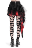 Back view of a black and red tiered gothic skirt with tulle, paired with edgy lace-up leggings.