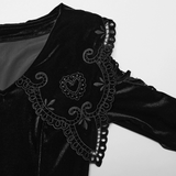 Close-up of velvet dress collar with intricate lace trim and heart-shaped applique detailing, showcasing gothic elegance.